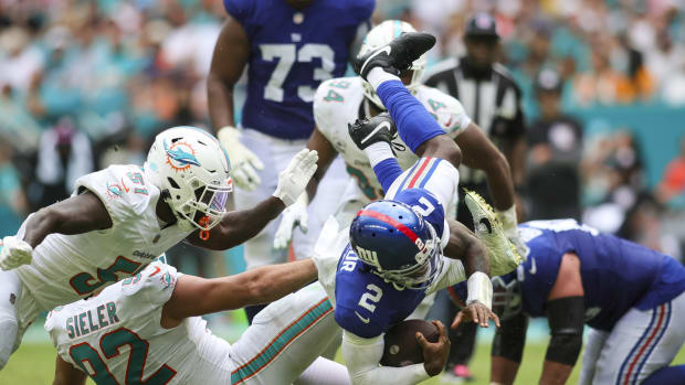 Oct 8, 2023; Miami Gardens, Florida, USA; New York Giants quarterback Tyrod Taylor (2) is tackled after running with the football against the Miami Dolphins during the fourth quarter at Hard Rock Stadium.